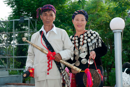 An unidentified elderly Kachin male and an elderly woman wearing in traditional dresses   during a national cultural performance at the Thailand Cultural Center.のeditorial素材