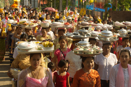 Thai food parade to eat sweet and savory food that Thai Mon minority people bring to the Wat Wangwiwegaram at Amphoe Sangkhlaburi, Kanchanaburi Province in Songkran festival.のeditorial素材