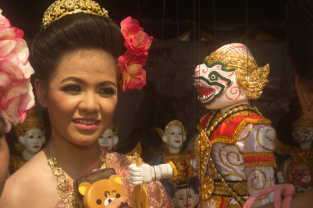 An unidentified of beautiful girls watching the Hanuman monkey puppet. At the Thai fair in the 232nd year of Rattanakosin city under Royal Benevolence in Bangkok, Thailand.のeditorial素材