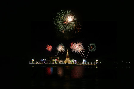 Samut Prakan , Thailand - Nov 11 , 2023 : Night time of the most important places of worship at  Phra Samut Chedi or Phra Chedi in the middle of water and a firework.のeditorial素材