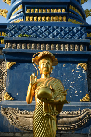 Sculptures of golden Phra Buakhem adorn the outdoor at Wat Rong Suea Ten temple. Located at Chiang Rai Province in Thailand.の写真素材