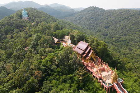 An aerial view of the outdoor Big Buddha, Daibutsu or Amitabe Buddha, and the Church at Wat Phra That Doi Prachan. Located at Lampang Province in Thailand.の写真素材
