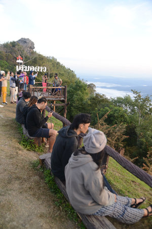 NAN , THAILAND - DECEMBER 4 , 2023 : Unidentified tourists at Doi Samer Dao in Sri Nan National Park. Who is watching the sunrise and sea mist in the morning.のeditorial素材