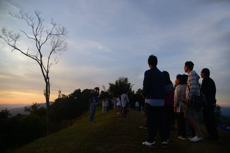 NAN , THAILAND - DECEMBER 4 , 2023 : Silhouettes of unidentified tourists at Doi Samer Dao in Sri Nan National Park. Who is watching the sunrise in the morning as the sun-up.のeditorial素材