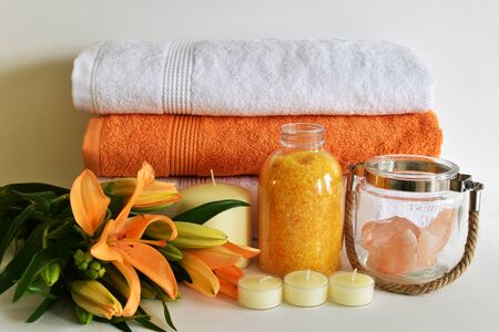 Spa concept of lily flower, towels, sea salt, candle and crystal rock