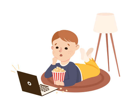 Cute Boy Lying on the Floor with Popcorn In Front of Laptop Watching Movie Vector Illustrationのイラスト素材
