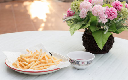 French Fries and flower on a tableの写真素材