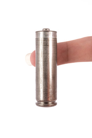 the isolated of hand hold is old AA battery on white background