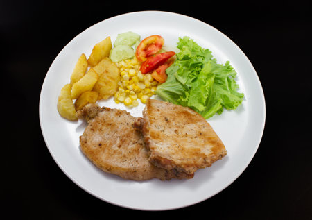 Pork chops steak with salad and french fried on studioの写真素材
