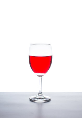 Red wine in glass on a white backgroundの写真素材
