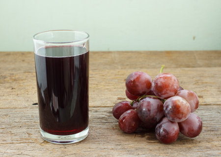 grape and juice on wood background.の写真素材