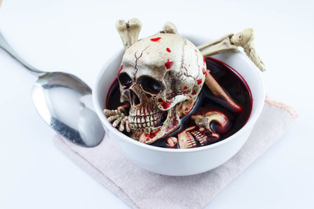 Skull and sweet blood in white cup on white backgroundの写真素材
