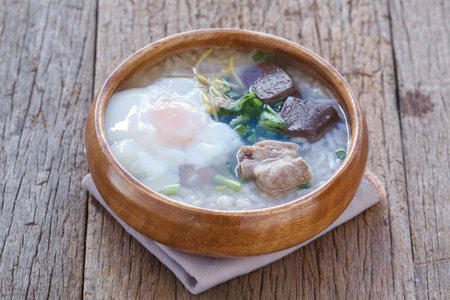 Rice porridge with pork ribs on wood background.の写真素材