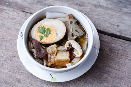 Chinese roll noodle soup on wood background, street food, Selection focusの写真素材