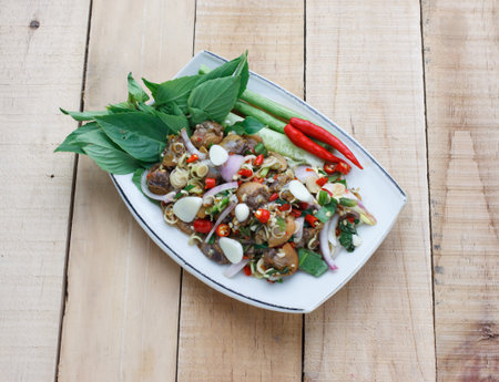 spicy cockle salad on wooden background, selection focusの写真素材