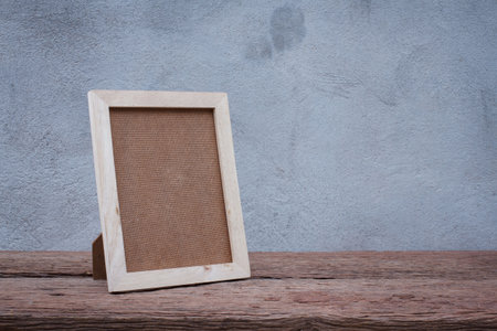 Blank wooden picture frame on wood table,interior design and copy spaceの写真素材