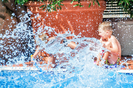 Splash water in the pool against the background of playing children
の写真素材