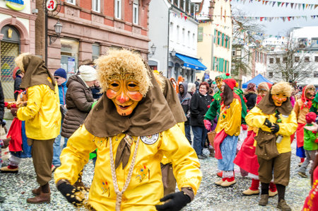 Germany, Lahr - JANUARY 17: Participants in costumes perform a street procession Carneval Fasnacht January 17, 2016 in the city of Lahr, Germany. They perform Gugge Music and dress up as witches.のeditorial素材