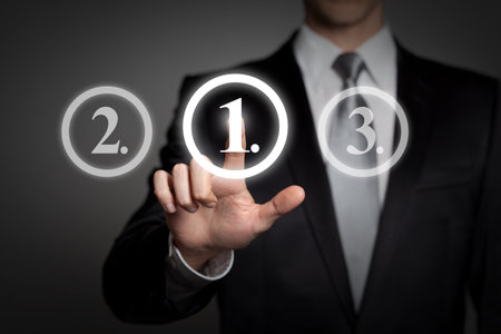 business concept - businessman in suit presses virtual touchscreen interface button - ranking first placeの写真素材