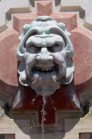 a stone face on the side of a building is a fountainの写真素材