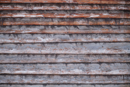 Old wooden wall from logs with tow, background textureの写真素材