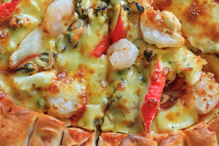 Seafood pizza with sausage, shrimps, crab and mussel backgroundの写真素材
