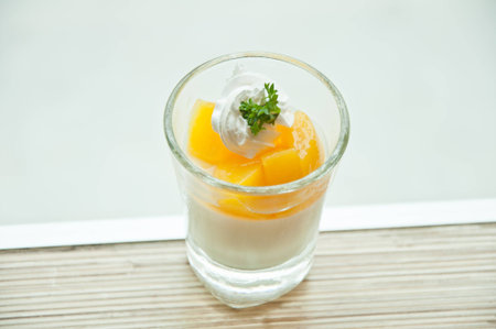 cup of orange panna cotta on the table in white background 