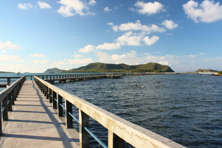 concrete jetty with railing over sea at Sattaheep beach, Thailandの写真素材