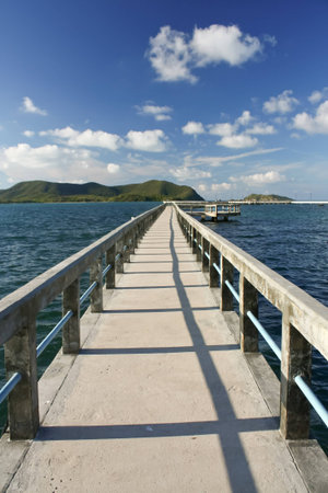 concrete jetty with railing over sea at Sattaheep beach, Thailandの写真素材