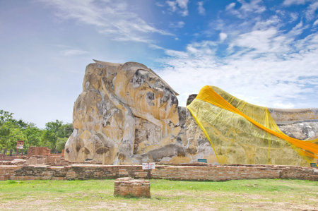 Ancient sleeping buddha statue at Wat Lo Ka Ya Su Tha temple in Ayutthaya, Thailandの写真素材