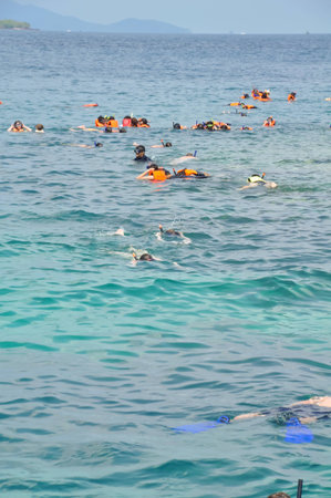 Active traveler diving snorkeling in beautiful clean ocean on summer vacation at Chang island, Thailandの写真素材