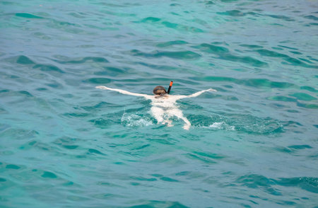 Active traveler diving snorkeling in beautiful clean ocean on summer vacation at Chang island, Thailandの写真素材