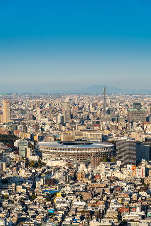 TOKYO, JAPAN - November 30, 2019 : Overhead aerial view of the new National Stadium with Tokyo's skyline, fully completed main stadium for Olympic Summer Games 2020 at sunset.のeditorial素材
