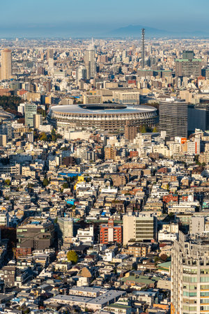 TOKYO, JAPAN - November 30, 2019 : Overhead aerial view of the new National Stadium with Tokyo's skyline, fully completed main stadium for Olympic Summer Games 2020 at sunset.のeditorial素材