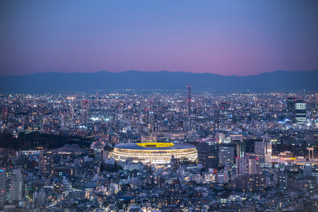 TOKYO, JAPAN - November 30, 2019 : Overhead aerial view of the new National Stadium with Tokyo's skyline in twilight time, fully completed main stadium for Tokyo Olympic Summer Games 2020のeditorial素材