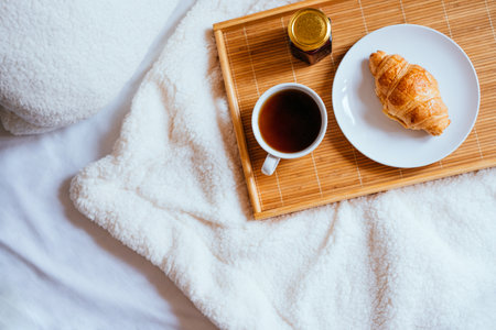 Coffee and croissant in bedの写真素材