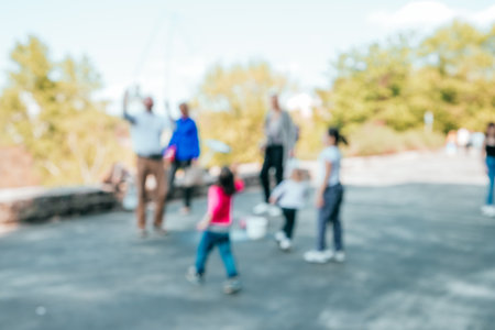 Blurred background with group of kids playing outside.の写真素材
