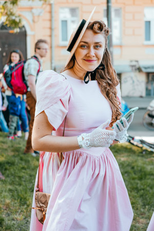 Kiev, Ukraine - May 12, 2018: Girl in pink vintage dress participating in bicycle tweed run Retro cruise on May 12, 2018 in Kiev, Ukraine.のeditorial素材
