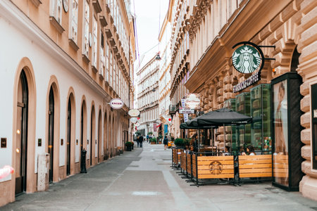Vienna, Austria - May 8, 2018: Cityscape view on the beautiful streets of Vienna with Starbucks cafe, tourists and hotels.のeditorial素材