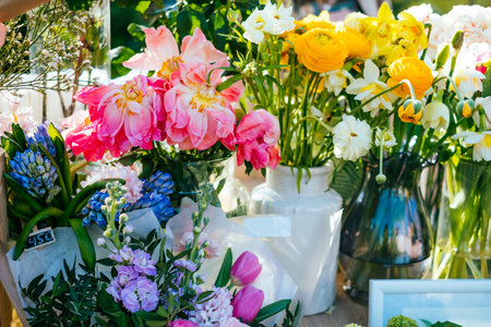 Beautiful pink peonies, yellow ranunculus flower bouquet and others. Spotted on the flower market.の写真素材