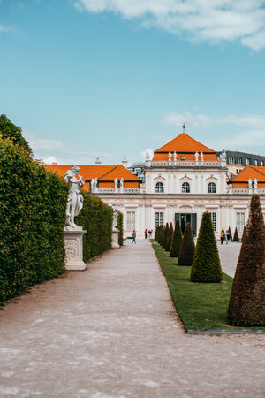 Antique sculpture and Belvedere garden with clipped bushes in Vienna, Austria in a beautiful spring dayのeditorial素材