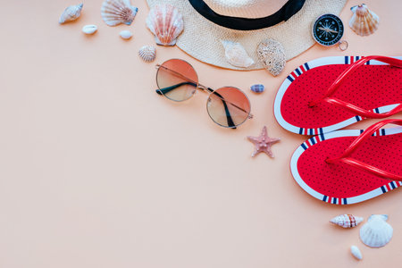 Summer fashion flatlay with gradient round sunglasses, straw hat, flats and red striped bikini top. Decorated with sea shells. Perfect beach set for holidays on the sea. Marina style.の写真素材
