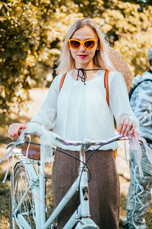 Kiev, Ukraine - May 12, 2018: Girl in white vintage blouse and pants participating in bicycle tweed run Retro cruise on May 12, 2018 in Kiev, Ukraine.のeditorial素材