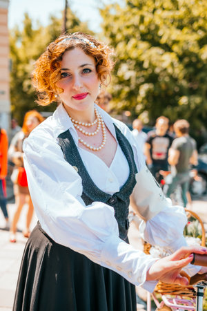 Kiev, Ukraine - May 12, 2018: Girl in vintage shirt and pearl necklace participating in bicycle tweed run Retro cruise on May 12, 2018 in Kiev, Ukraine.のeditorial素材