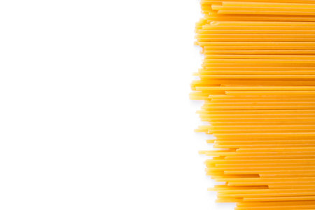 Raw spaghetti pasta backgroung. Flatlay style, top view. Traditional italian cuisine.の写真素材