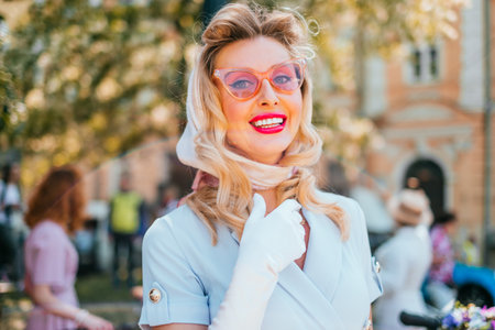 Kiev, Ukraine - May 12, 2018: Girl in light blue color vintage dress, sunglasses, silk scarf, socks...