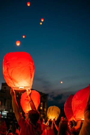 Kiev, Ukraine - June 13, 2018: Group of people launching sky lantern at the festival to the night sky.のeditorial素材