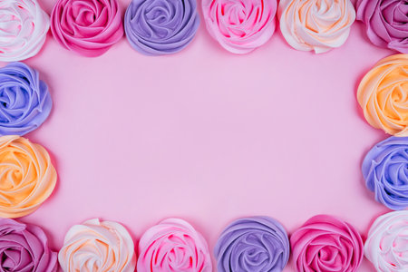 Beautiful pink, magenta, orange and violet rose flower shaped meringue flatlay.の写真素材