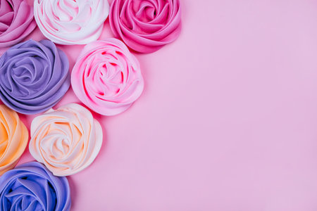 Beautiful pink, magenta, orange and violet rose flower shaped meringue flatlay.の写真素材