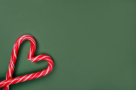 Christmas inspired flatlay with candy canes on the bright green background.の写真素材